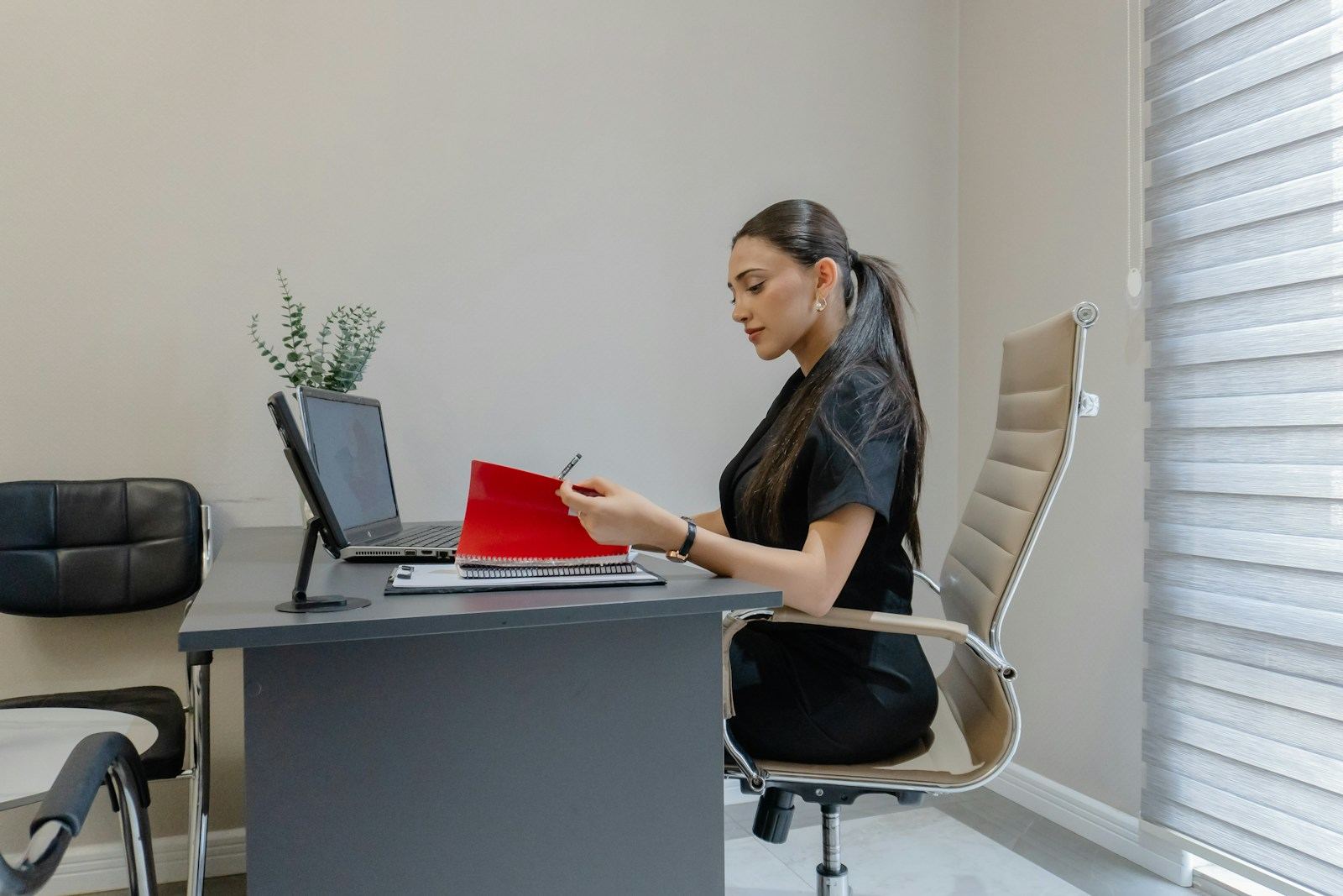 Elena Ruiz reviewing client files at her desk