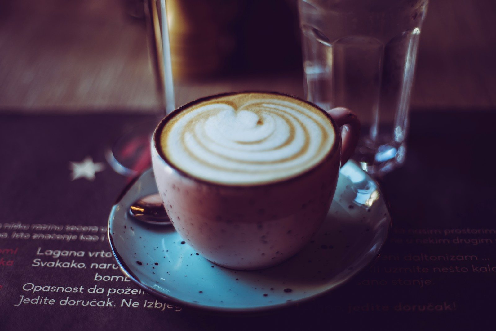 A frothy Fungi Fuel latte in a speckled cup