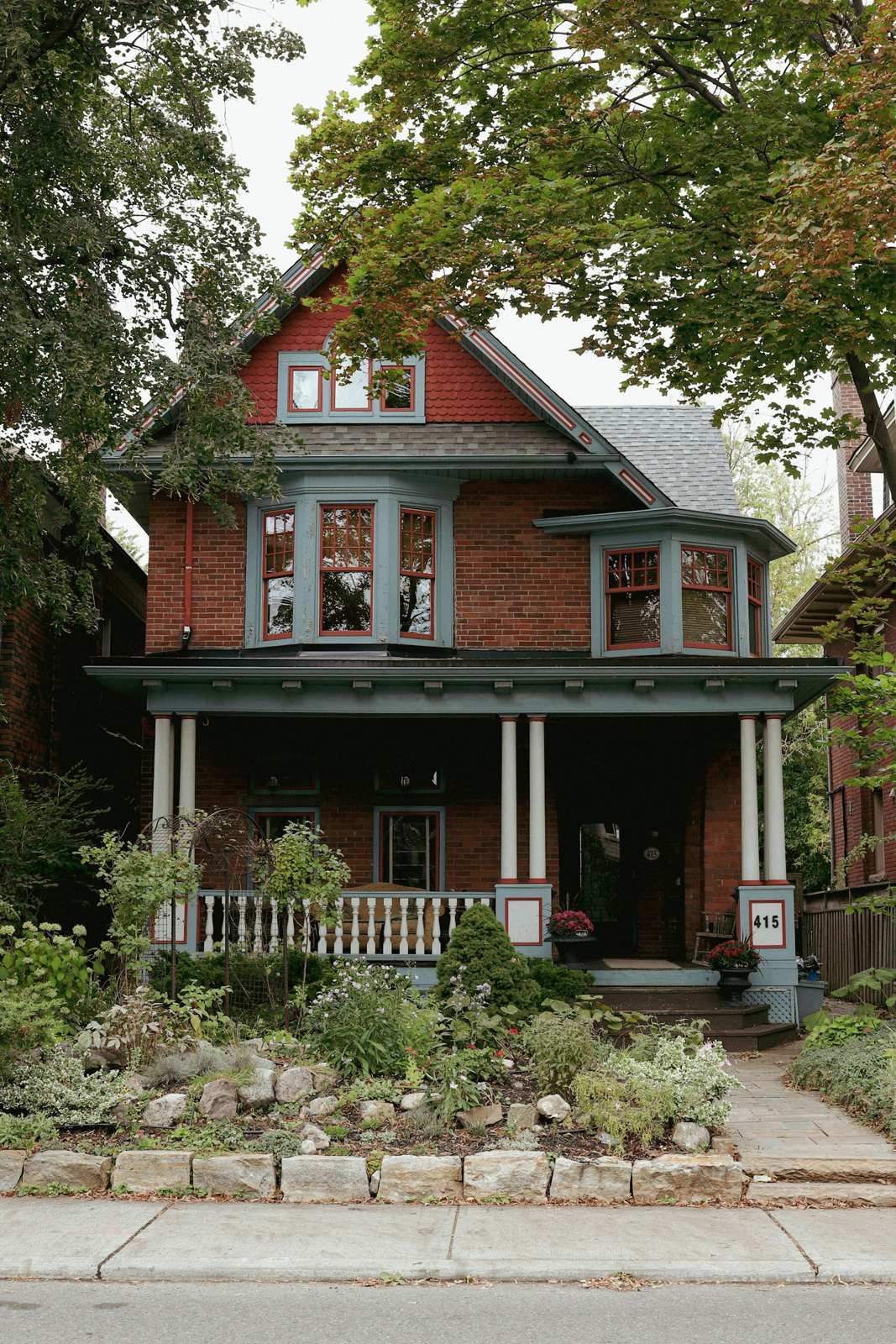 Red brick family home with a covered front porch